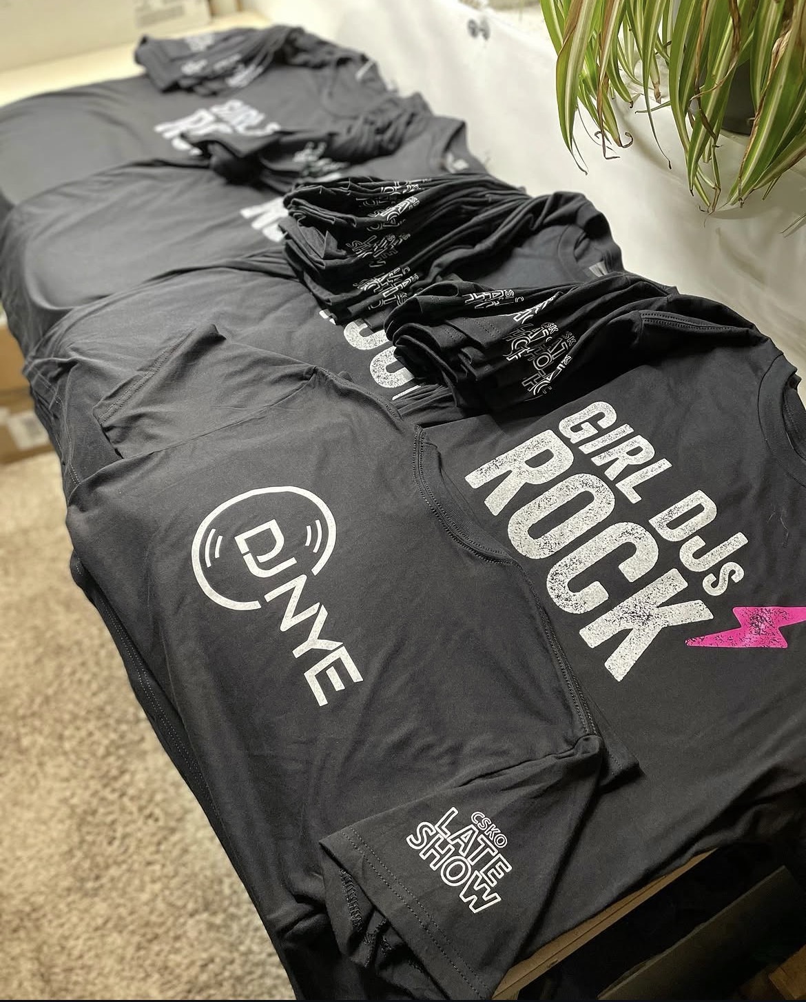 DJ NYE 'Girl DJs Rock' black tees with distressed white print and pink lightning bolt accent