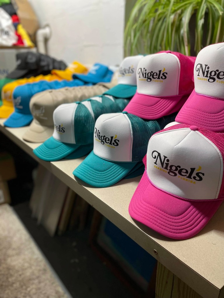 Nigel's Seaside Florida trucker hats in pink, teal, blue, and tan