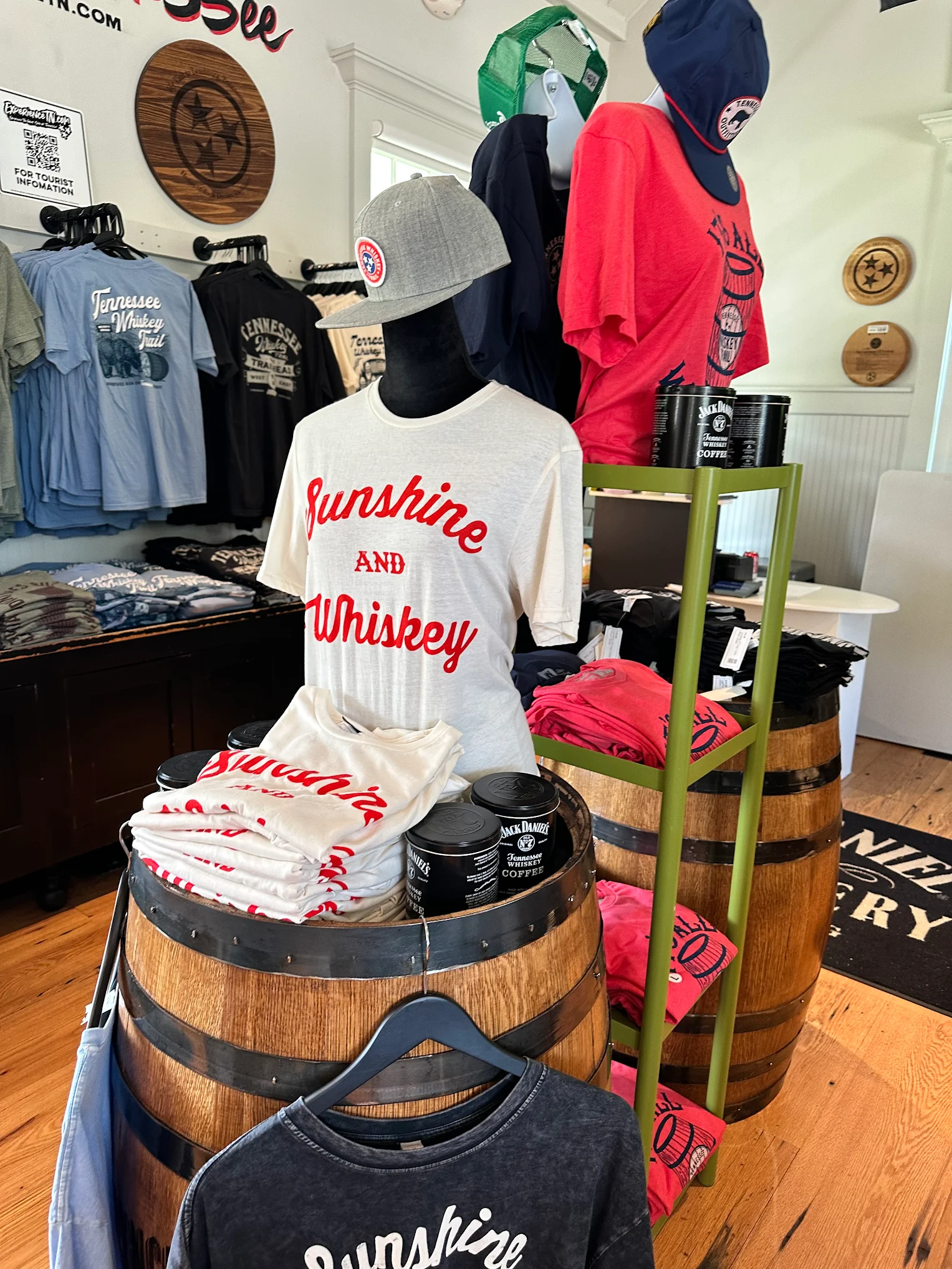 Sunshine and Whiskey retail display — printed tees on whiskey barrels and mannequins