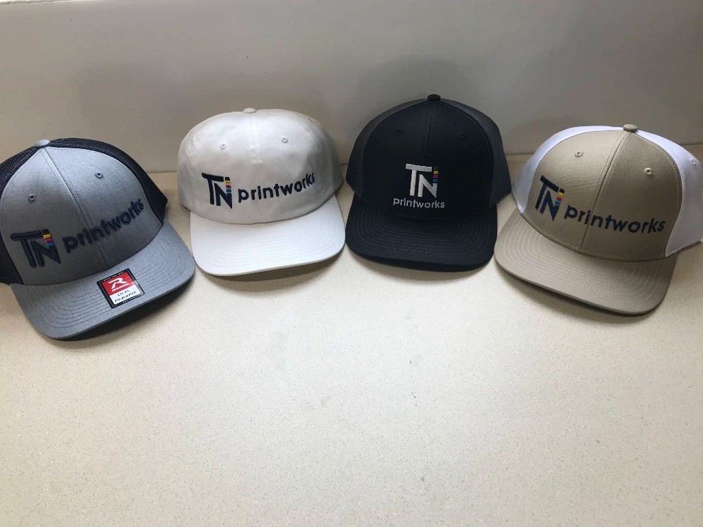 TN Printworks branded snapback hats in four colorways